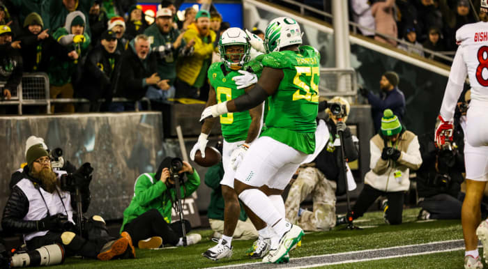Oregon Ducks running back Bucky Irving celebrates a touchdown against Utah with offensive lineman Marcus Harper II.